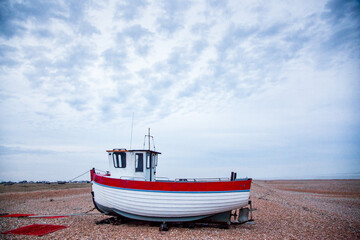 Naklejka na ściany i meble deserted coast of Dungeness with old fishing boats
