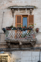 Fototapeta na wymiar balcony in a narrow alley of Ostunis oldtown, Puglia