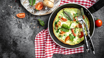 Healthy frittata in pan with eggs, cheese and spinach salad. Italian omelette Keto, ketogenic lunch