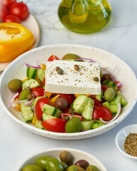 Greek village salad horiatiki with feta cheese and vegetables, vegeterian mediterranean food, low calories keto dieting meal, side view, close up