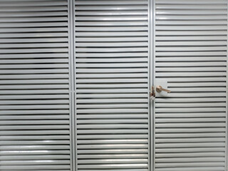 Gray steel door with bars closeup with space to write your text