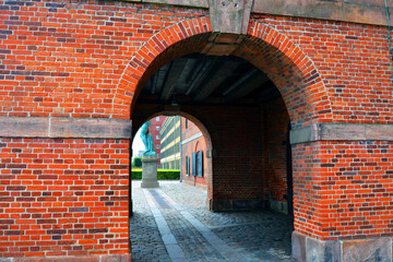 Arched passage in an old brick building on the embankment in Copenhagen, Denmark