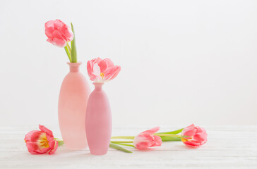 tulips in pink vase on white table