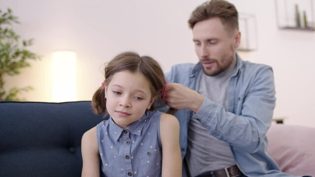 Single dad trying to do daughter's hair, difficulties of parenthood, upbringing