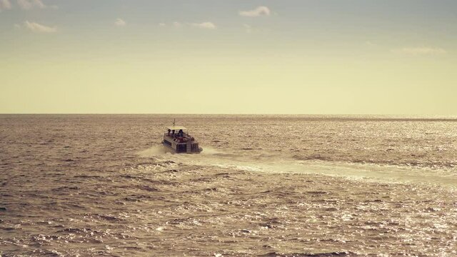 Small boat in the sea at Mount Athos at sunrise