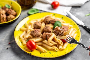 Meatball with penne pasta on fork, banner, menu recipe, top view