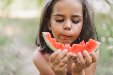 The girl is eating a watermelon. Summer mood.