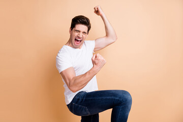 Profile side photo of lucky cheerful man closed eyes scream yeah raise fists isolated on pastel...