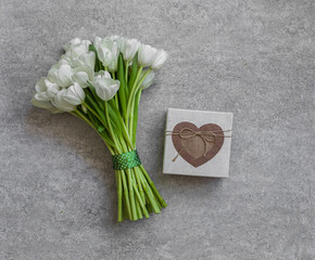 White tulips and gift box on background. Spring concept.