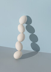 Minimal composition made of white Easter eggs against bright blue and gray background. Creative  food concept.