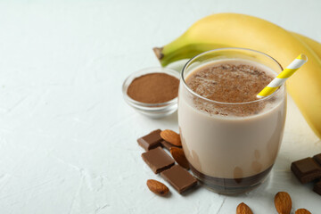 Concept of delicious food with chocolate milkshake and banana on white textured table