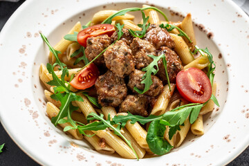 Close-up of Italian pasta with tomato sauce and meatballs. Food recipe background. Close up