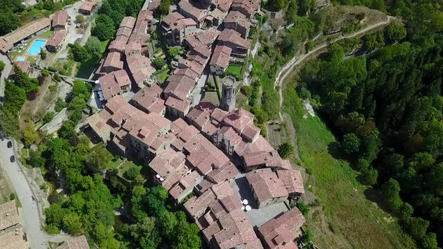 Aerial Descend Tilt Up: Houses In Scenic Town On Sunny Day