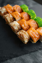 Sushi set with different species on a black background