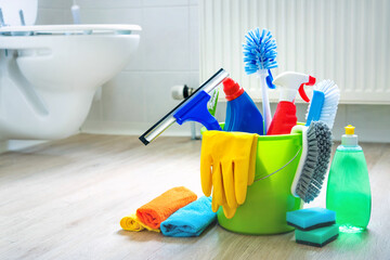 Various cleaning items and supplies in a bucket on the bathroom floor © Alexander Raths
