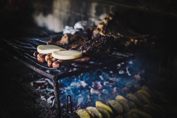 Tipico asado argentino con carne y patatas hecho a las brasas