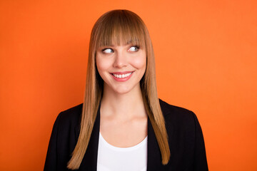 Photo of optimistic nice blond hair lady look empty space wear black jacket isolated on bright orange color background