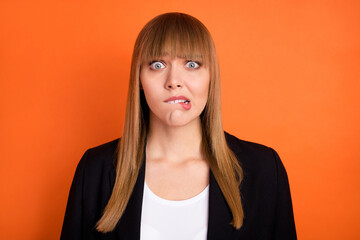 Photo of sad nice blond hair lady bite lip wear black jacket isolated on bright orange color...