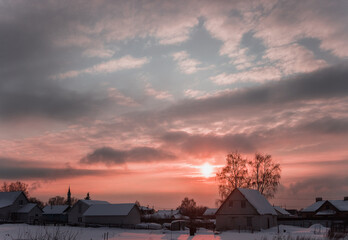 Obraz premium Evening winter sunset in the village