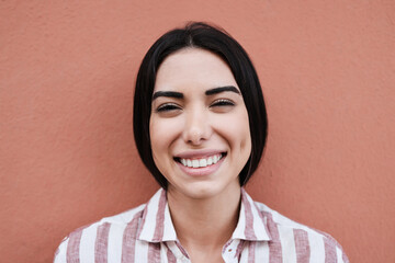 Young latin woman smiling on camera - Focus on face