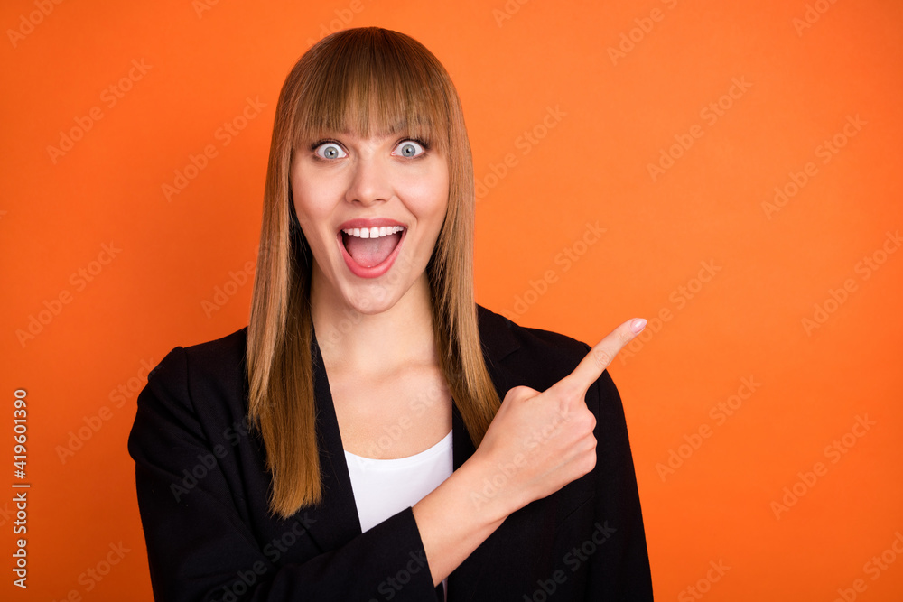 Wall mural Photo of impressed nice blond hair lady point empty space wear black jacket isolated on bright orange color background