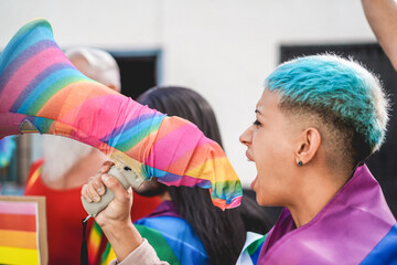 Lesbian demonstrator screaming at lgbt pride protest for equality rights - Main focus on megaphone