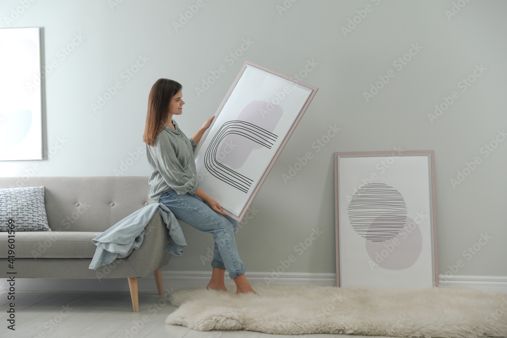 Sticker woman holding picture near wall in room. interior design