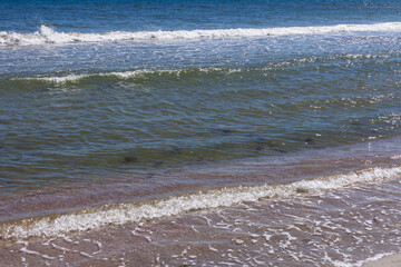 The background of sand with water splash into summer with space for text.