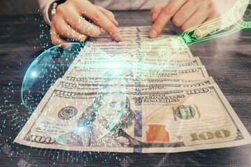 Double exposure of technology drawing hologram and us dollars bills and man hands. Data concept