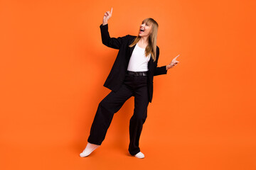 Fototapeta na wymiar Full size photo of happy excited good mood funky funny girl dancing look copyspace isolated on orange color background