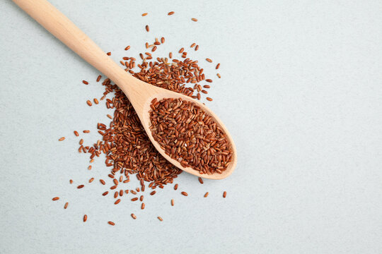 Brown GABA rice in wooden spoon, top view. Selective focus, place for text