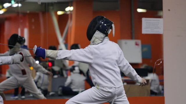 Kids practicing fencing at a fencing school 