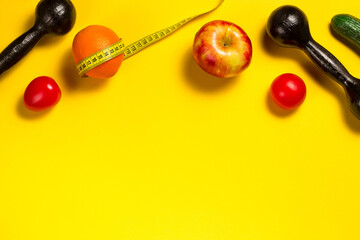 Creative flat lay of fitness equipment and fruits and vegetables on the yellow. Healthy lifestyle concept. Copy space. Orange with a tape measure, summer body concept. Trend color of the year 2021