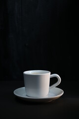 Obraz na płótnie Canvas a cup of coffee on a dark background