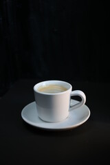 Obraz na płótnie Canvas a cup of coffee on a dark background