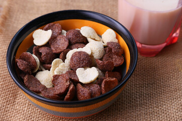 close up of corn flakes in a bowl on table 