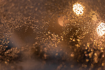 Blurred background with raindrops and lights.