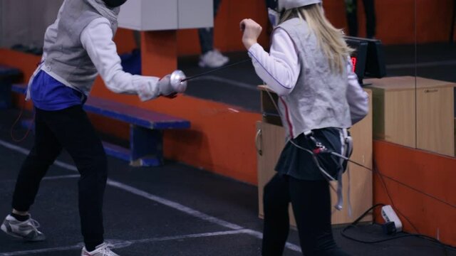 Teenagers practicing fencing at a fencing school 