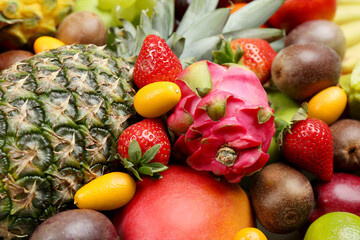 Assortment of fresh exotic fruits as background, closeup