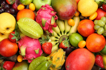 Assortment of fresh exotic fruits as background, top view