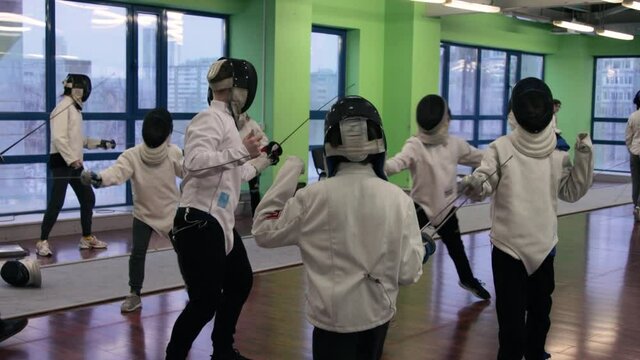 Kids practicing fencing at a fencing school 
