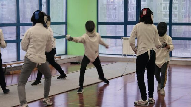 Kids practicing fencing at a fencing school 