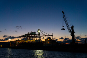 02 March 2021 Russia, Novorossiysk. International trade port with a crane for sea containers in the evening.