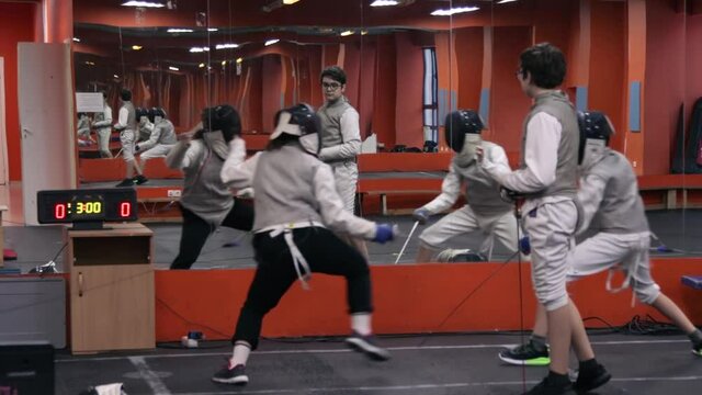 Kids practicing fencing at a fencing school 