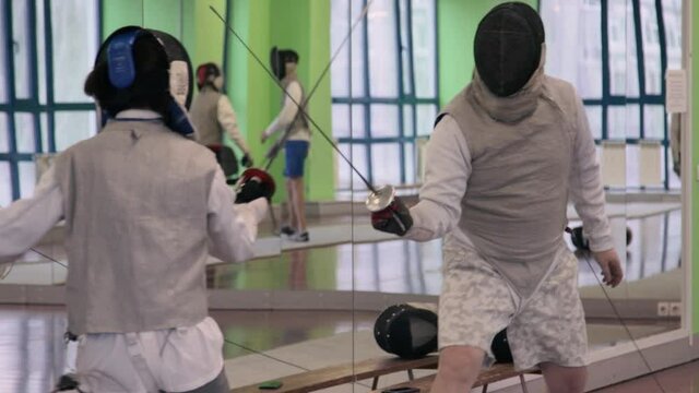 Fencing coach working with his student