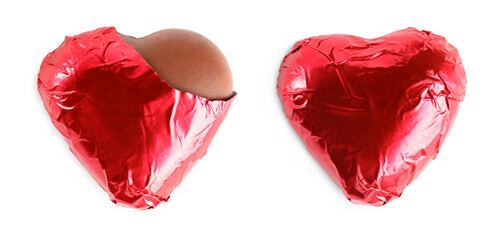 Delicious heart shaped chocolate candies on white background, top view