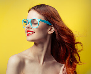 pretty woman naked shoulders red lips blue glasses yellow background