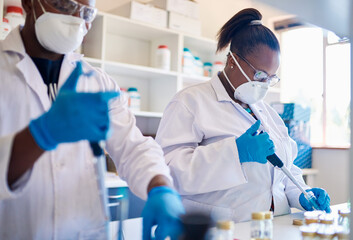 African technicians analyzing samples while working in a lab