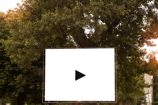 Open air cinema or theater, outdoors movie. Large movie screen, film playing on the park background