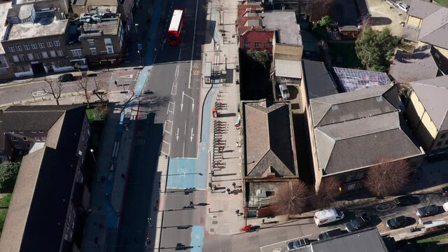 Pan up reveal aerial drone shot of city of London buildings from Whitechapel road